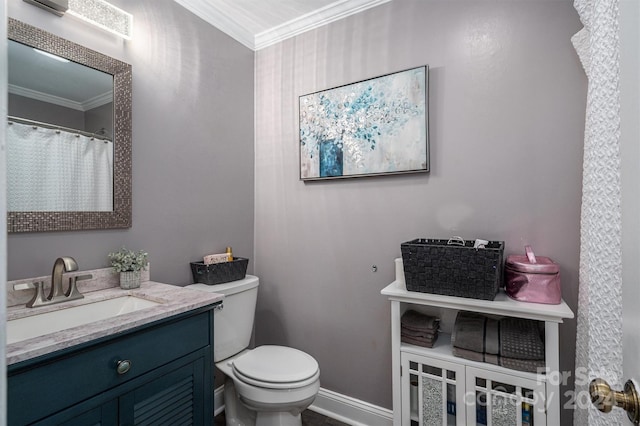 bathroom with vanity, ornamental molding, and toilet