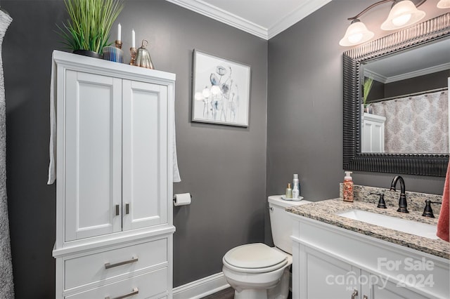 bathroom featuring vanity, toilet, and crown molding