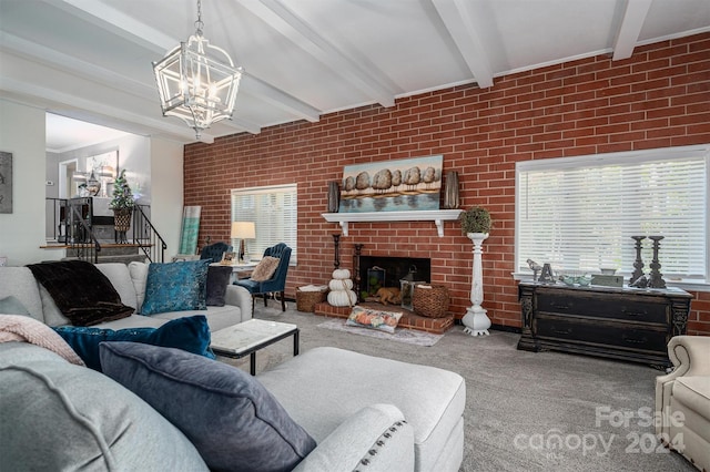 carpeted living room with an inviting chandelier, beam ceiling, brick wall, and a fireplace