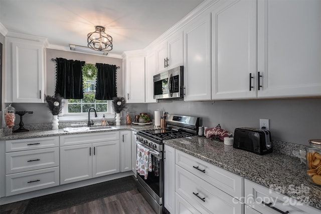 kitchen featuring sink, appliances with stainless steel finishes, white cabinets, and dark hardwood / wood-style flooring