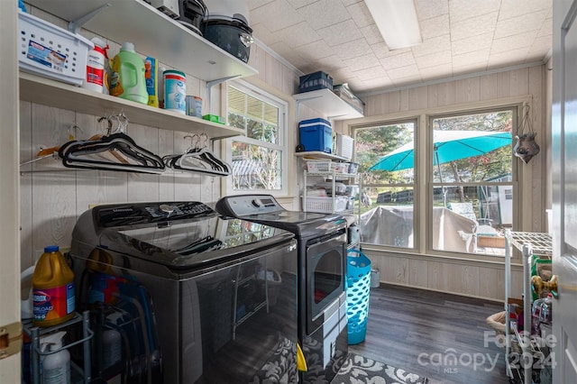 washroom with wood walls, dark hardwood / wood-style flooring, and separate washer and dryer