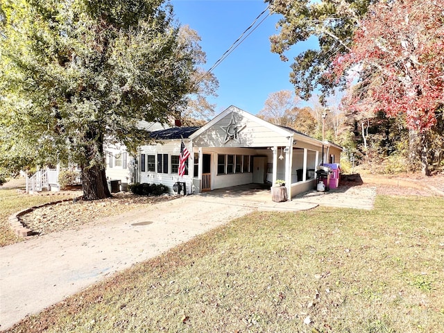 view of front of house with a front lawn and a carport