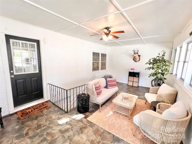 interior space with ceiling fan