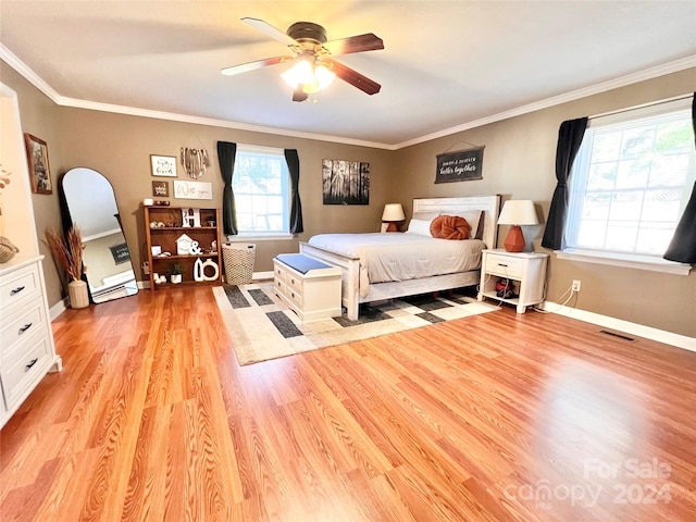 bedroom featuring ceiling fan, crown molding, and light wood-type flooring