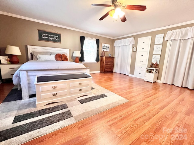 bedroom with ceiling fan, light hardwood / wood-style floors, and crown molding