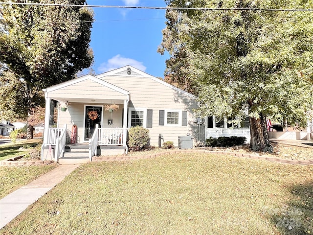 402 Sharon Ave, Lenoir, NC 28645 - bungalow featuring covered porch, central AC unit, and a front lawn