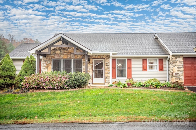 267 Rocky Mountain Way, Arden, NC 28704 - view of front facade featuring stone siding, roof with shingles, a front yard, and a garage