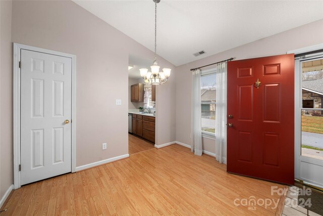267 Rocky Mountain Way, Arden, NC 28704 - entryway featuring a chandelier, vaulted ceiling, light wood-style floors, and baseboards