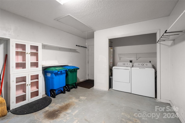 laundry room with washing machine and dryer and a textured ceiling