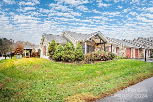 267 Rocky Mountain Way, Arden, NC 28704 - view of front of property with an attached garage, a front yard, stone siding, and asphalt driveway