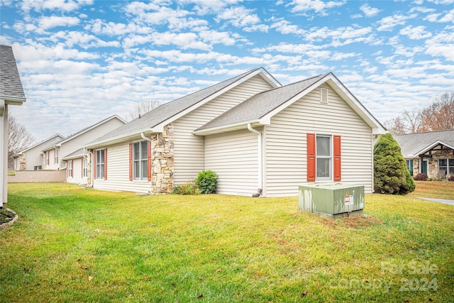 view of side of home with a lawn