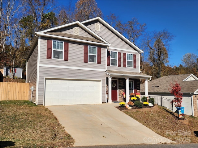 view of front facade featuring a garage, covered porch, and a front lawn