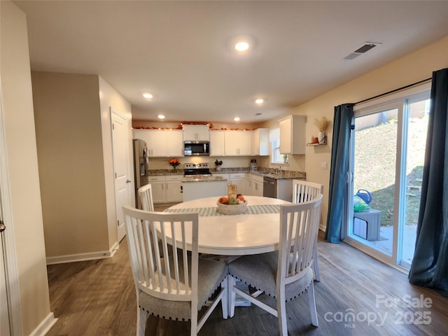 dining room with dark hardwood / wood-style flooring