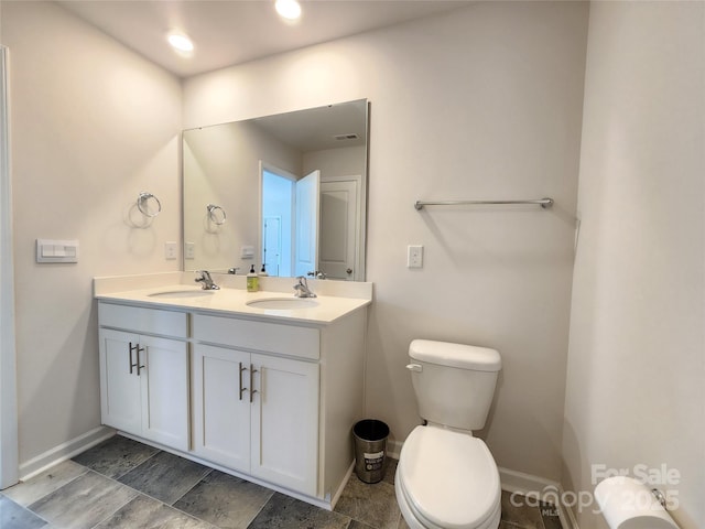 bathroom with toilet and vanity