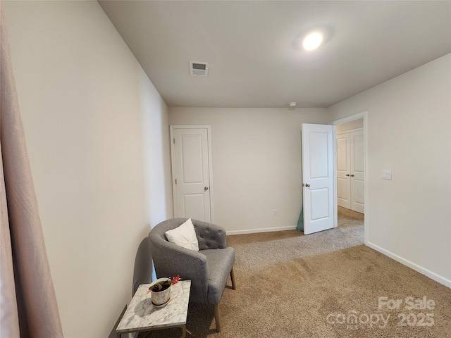 sitting room featuring light colored carpet