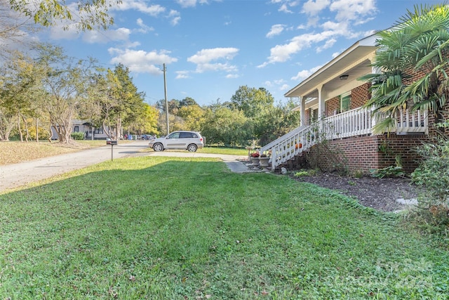 view of yard with covered porch