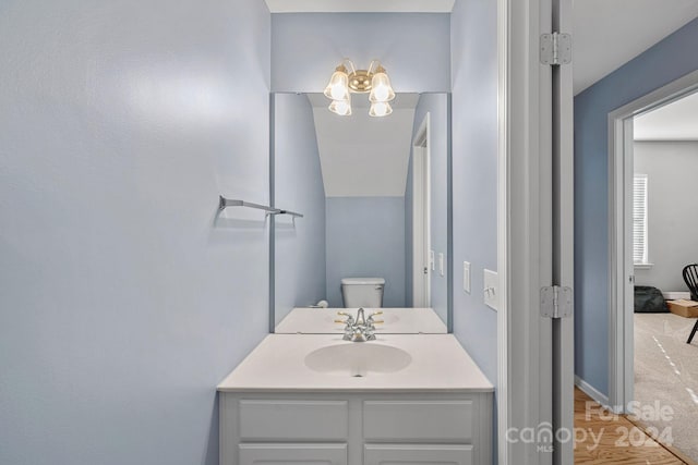 bathroom featuring vanity and toilet