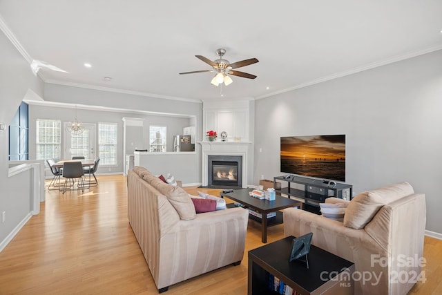 living room featuring light hardwood / wood-style flooring and crown molding