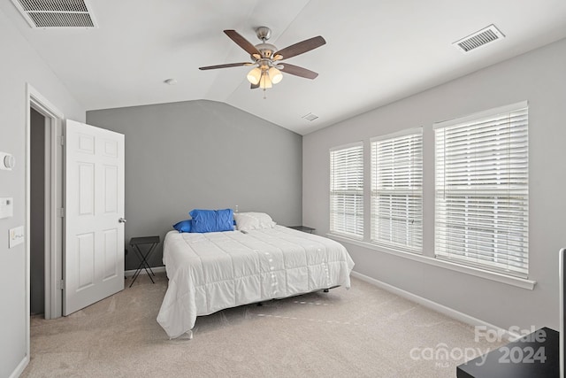 carpeted bedroom featuring vaulted ceiling and ceiling fan