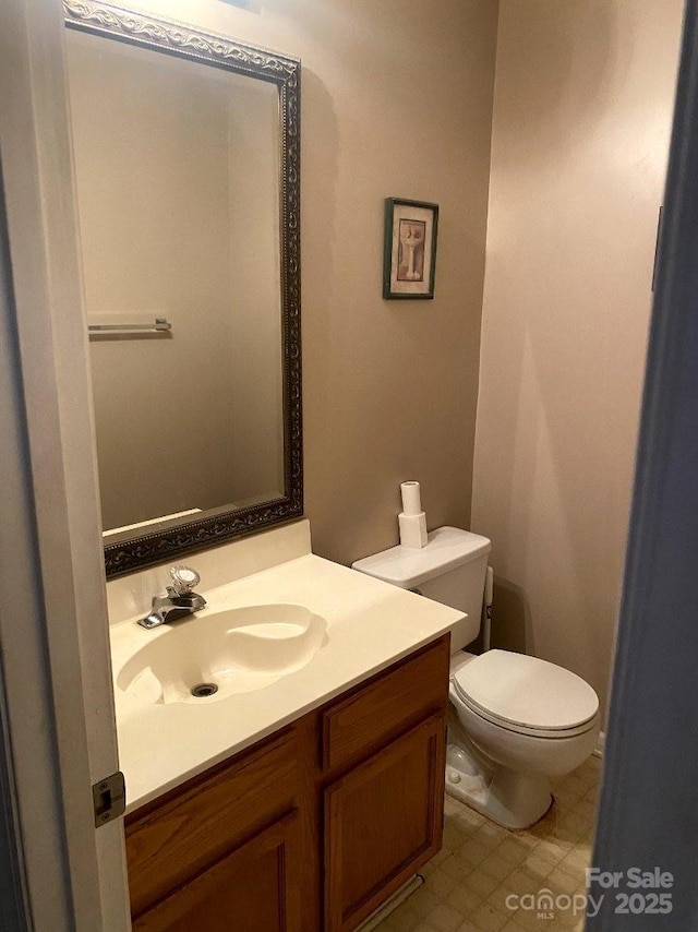 bathroom featuring vanity and toilet