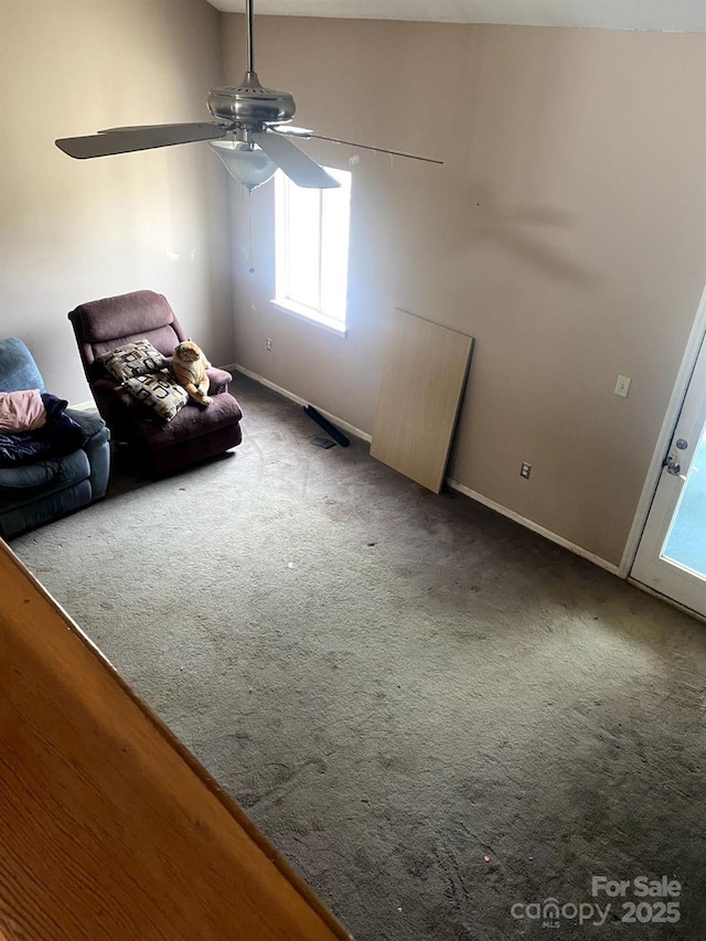 interior space with ceiling fan and carpet flooring