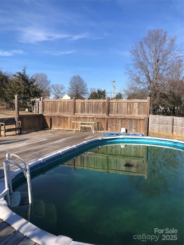 view of swimming pool featuring a deck