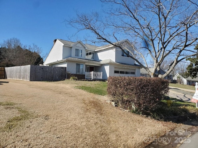 view of side of home featuring a garage and a lawn