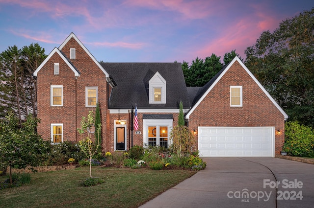 view of front of property featuring a yard and a garage