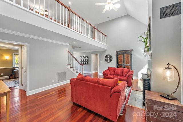 living room featuring crown molding, dark hardwood / wood-style floors, high vaulted ceiling, and ceiling fan