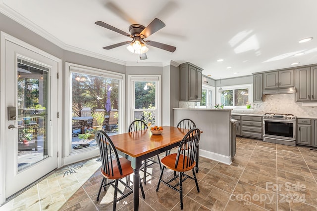 dining space featuring ornamental molding and ceiling fan