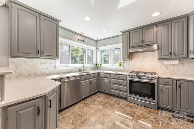 kitchen featuring crown molding, appliances with stainless steel finishes, sink, and gray cabinets