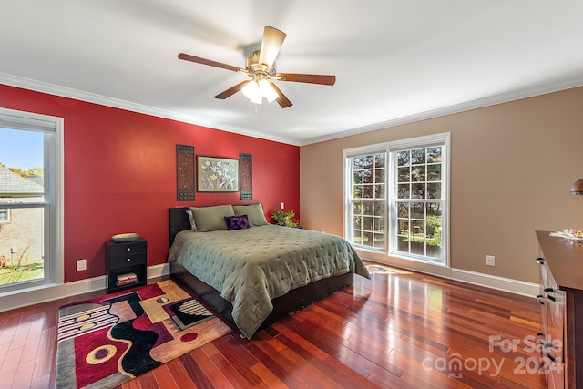 bedroom with multiple windows, ornamental molding, wood-type flooring, and ceiling fan