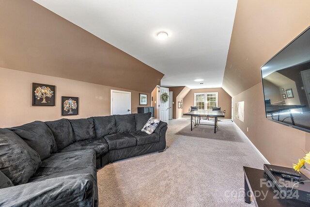 carpeted living room with vaulted ceiling