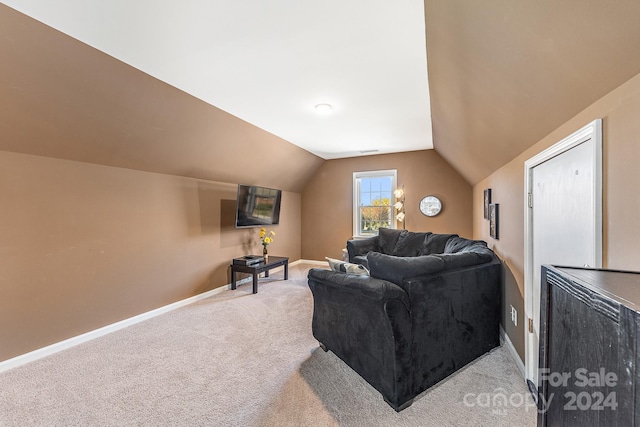 living room featuring lofted ceiling and light colored carpet