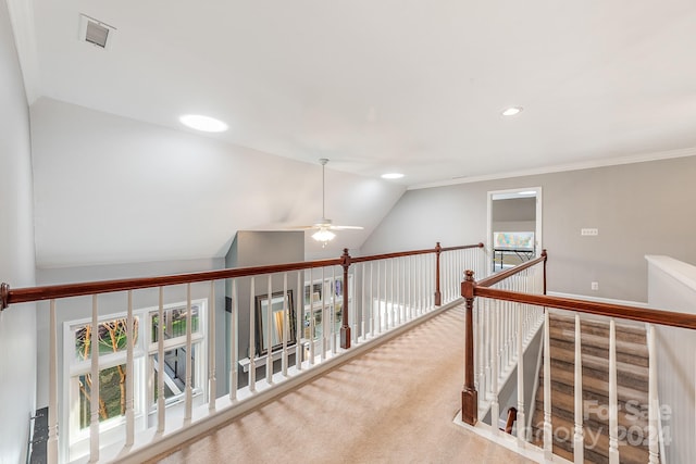 hall with vaulted ceiling and light carpet