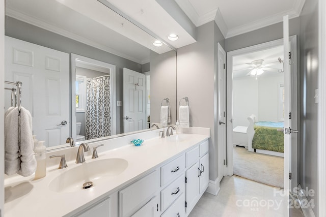 bathroom featuring vanity, toilet, crown molding, and ceiling fan