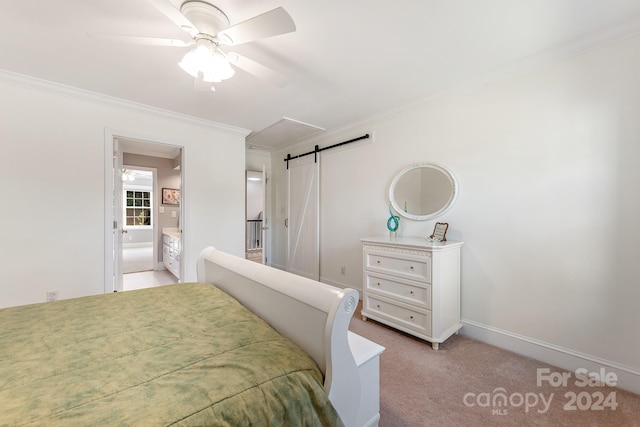 bedroom with ensuite bathroom, a barn door, ceiling fan, ornamental molding, and light colored carpet