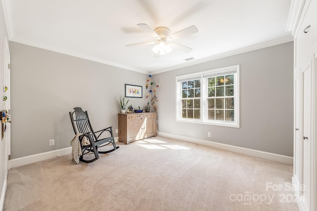 interior space with ornamental molding, light colored carpet, and ceiling fan