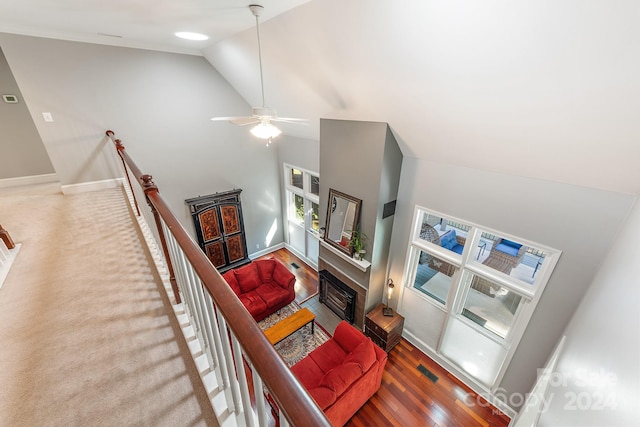 living room featuring hardwood / wood-style floors, high vaulted ceiling, and ceiling fan