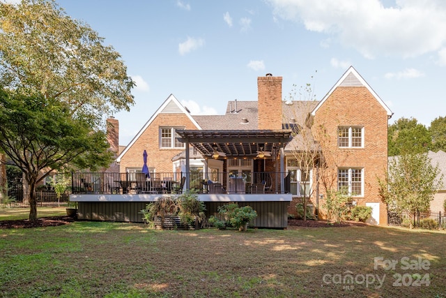 back of property featuring a deck and a yard