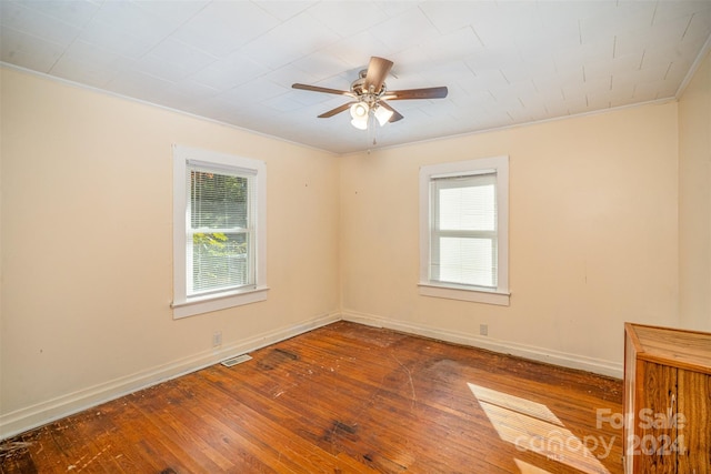 spare room featuring crown molding, hardwood / wood-style flooring, and ceiling fan