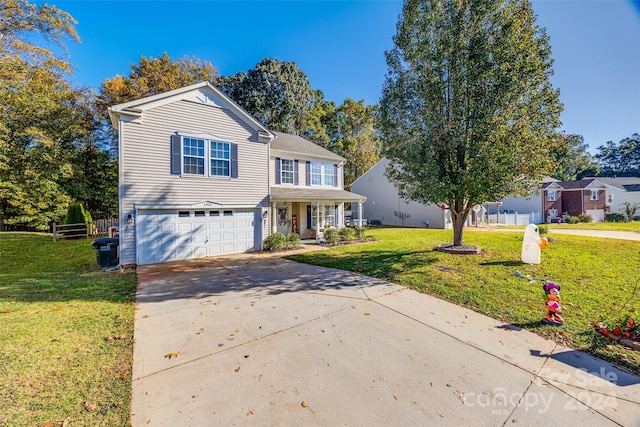 view of front of property featuring a porch, a front yard, and a garage