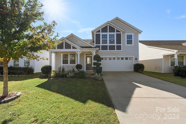 view of property with a front yard and a garage