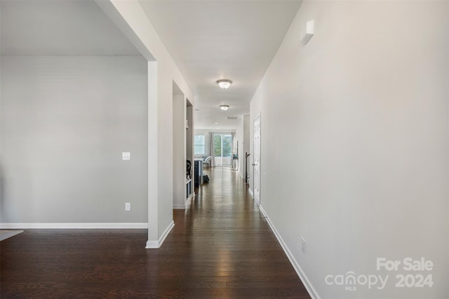 corridor featuring dark wood-type flooring