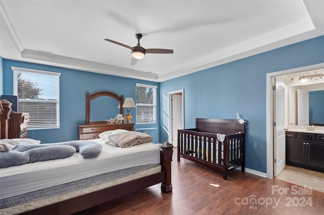 bedroom with ensuite bath, sink, crown molding, ceiling fan, and dark hardwood / wood-style flooring