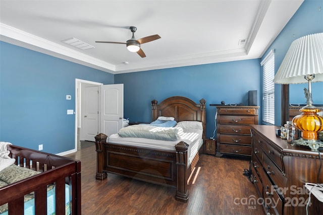 bedroom featuring ceiling fan, ornamental molding, and dark hardwood / wood-style flooring