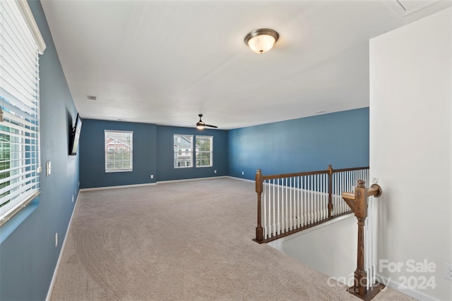 unfurnished room with carpet floors and ceiling fan