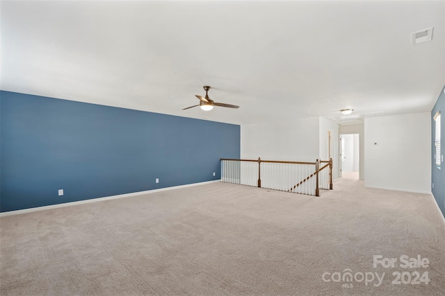 unfurnished room featuring light carpet and ceiling fan