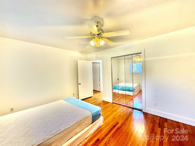 bedroom featuring wood-type flooring, a closet, and ceiling fan