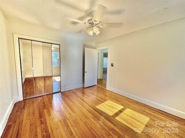 unfurnished bedroom featuring ceiling fan, a closet, and light hardwood / wood-style flooring